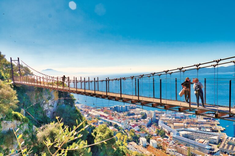 Gibraltar, Gibraltar - February 9, 2019: Tourists in Gibraltar crossing the Windsor suspension bridge, from where you can enjoy awesome views